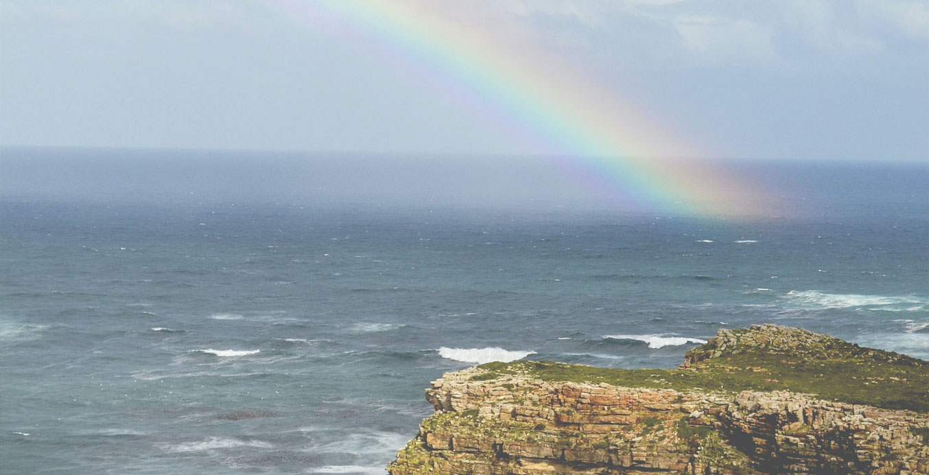 Trauerbewältigung – Ein Felsen im Meer und Regenbogen